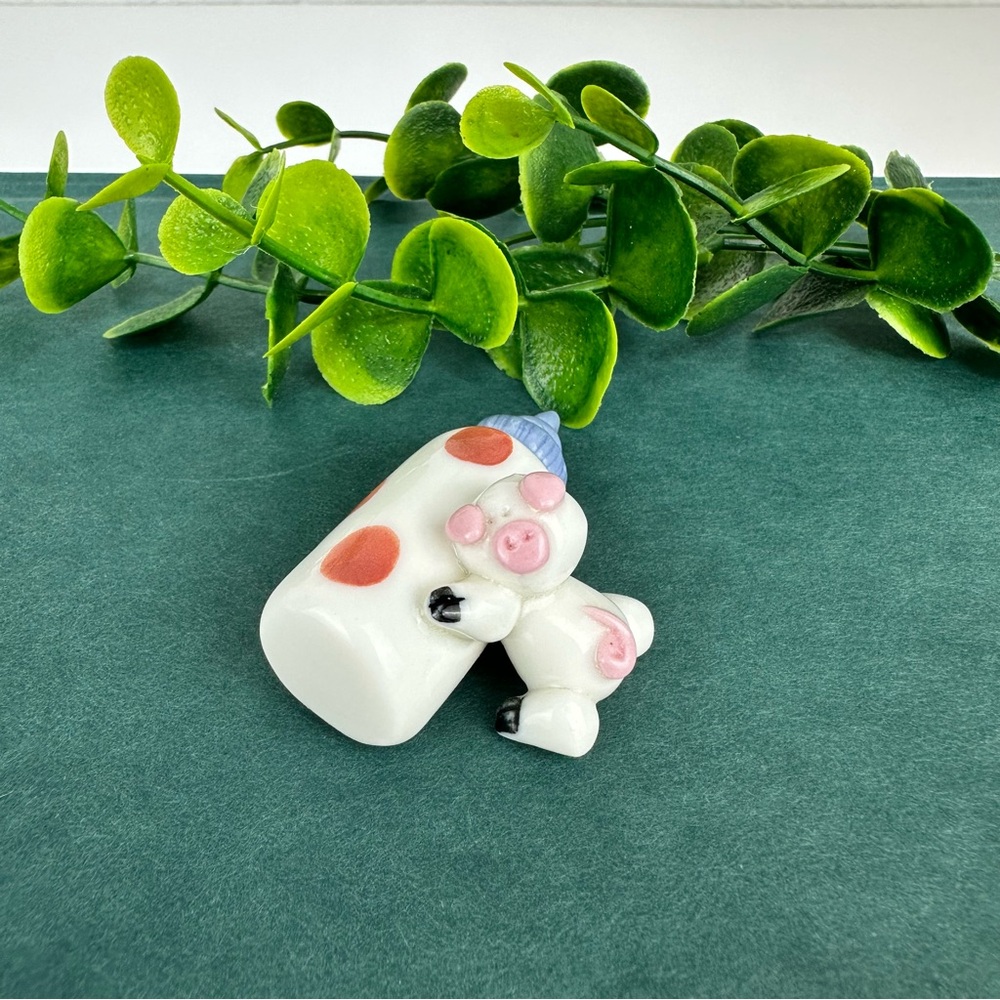 Vintage Mini Pig Figurine Laying on a Milk Bottle